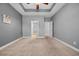 Large bedroom with neutral carpet and paint and doorway to bathroom at 605 Fieldwoods Dr., Conway, SC 29526
