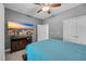 Comfortable bedroom features a ceiling fan, TV, and natural light from the windows at 605 Fieldwoods Dr., Conway, SC 29526
