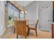 Bright dining area features a glass table and wicker chairs near a sunny window at 605 Fieldwoods Dr., Conway, SC 29526