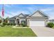 Charming single-story home with well-manicured lawn and attached two-car garage at 605 Fieldwoods Dr., Conway, SC 29526