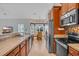Well-equipped kitchen with stainless appliances and eat-in dining area with natural light at 605 Fieldwoods Dr., Conway, SC 29526