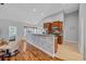 Open concept kitchen boasts wood cabinetry and a breakfast bar with decorative wood trim at 605 Fieldwoods Dr., Conway, SC 29526