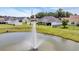 Scenic pond view with fountain, surrounded by lush landscaping and well-maintained backyard and fence at 605 Fieldwoods Dr., Conway, SC 29526