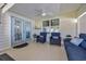 Relaxing covered porch with blue furniture, ceiling fan, and great lighting at 605 Fieldwoods Dr., Conway, SC 29526