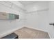 Spacious walk-in closet provides ample storage with wire shelving and neutral carpeting at 605 Fieldwoods Dr., Conway, SC 29526