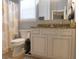 Bathroom featuring a single sink vanity with granite counters, a toilet, and a shower with curtain at 620 Wave Rider Ln. # B10-1, North Myrtle Beach, SC 29582