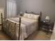 Comfortable bedroom with a decorative metal bed frame, soft bedding, and ample natural light at 620 Wave Rider Ln. # B10-1, North Myrtle Beach, SC 29582