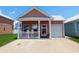 Charming single-story home featuring a welcoming front porch, tidy yard, and an attached single-car garage at 620 Wave Rider Ln. # B10-1, North Myrtle Beach, SC 29582