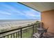 Balcony view with seating overlooking the sandy beach and the ocean at 6900 N Ocean Blvd. # 421, Myrtle Beach, SC 29572