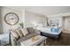 Well-decorated bedroom with a partial view of the ocean, featuring a sofa and a comfortable bed at 6900 N Ocean Blvd. # 421, Myrtle Beach, SC 29572