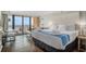 Bedroom with balcony access overlooking the ocean, featuring a comfortable bed and decor at 6900 N Ocean Blvd. # 421, Myrtle Beach, SC 29572