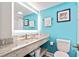 Modern bathroom with granite countertop, bright lighting, and blue accent wall at 7200 N Ocean Blvd. # 224, Myrtle Beach, SC 29572