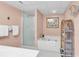 This bathroom features a shower, jacuzzi-style tub, and rattan shelving for storage at 741 Retreat Beach Circle # B-1-A, Pawleys Island, SC 29585