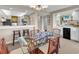 Open-concept living area adjacent to a dining area, complete with a bar and a view into the kitchen at 741 Retreat Beach Circle # B-1-A, Pawleys Island, SC 29585