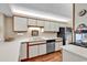 Efficient kitchen with white cabinets, stainless steel appliances, and ample counter space at 741 Retreat Beach Circle # B-1-A, Pawleys Island, SC 29585