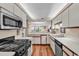 Bright kitchen with stainless appliances, and open view to the living area at 741 Retreat Beach Circle # B-1-A, Pawleys Island, SC 29585