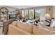 Bright living room boasts large windows, comfortable seating, and access to a private balcony at 741 Retreat Beach Circle # B-1-A, Pawleys Island, SC 29585