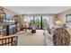 Inviting living room with balcony access showcasing natural light, cozy seating, and stylish decor at 741 Retreat Beach Circle # B-1-A, Pawleys Island, SC 29585