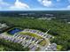 An aerial view of a neighborhood showcasing homes, a tranquil pond, and views of a verdant forest at 748 Old Murrells Inlet Rd., Murrells Inlet, SC 29576