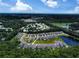 An aerial view showing a neighborhood nestled in a lush, green area, a pond, and distant ocean views at 748 Old Murrells Inlet Rd., Murrells Inlet, SC 29576