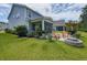Expansive backyard featuring an outdoor kitchen, fire pit, and manicured lawn, ideal for outdoor entertaining at 748 Old Murrells Inlet Rd., Murrells Inlet, SC 29576