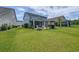 Lush backyard featuring an outdoor kitchen, fire pit, and manicured lawn, ideal for outdoor entertaining at 748 Old Murrells Inlet Rd., Murrells Inlet, SC 29576