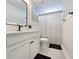 Bright bathroom featuring a modern vanity, a large mirror, and a shower with a stylish black and white striped curtain at 748 Old Murrells Inlet Rd., Murrells Inlet, SC 29576