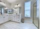 Bright bathroom features double sinks, white cabinetry and a glass door shower with tile surround at 748 Old Murrells Inlet Rd., Murrells Inlet, SC 29576