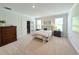 Bright bedroom with carpet, a large bed with decorative pillows, and natural light from two windows at 748 Old Murrells Inlet Rd., Murrells Inlet, SC 29576