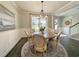 Bright dining room features a round table with seating for six and modern chandelier at 748 Old Murrells Inlet Rd., Murrells Inlet, SC 29576