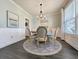 Stylish dining room with round table, six chairs, dark hardwood floors, and charming decor at 748 Old Murrells Inlet Rd., Murrells Inlet, SC 29576