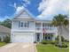 Charming two-story home with a welcoming front porch, a two-car garage, and well-maintained landscaping at 748 Old Murrells Inlet Rd., Murrells Inlet, SC 29576
