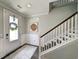 Inviting foyer with a stylish rug, elegant staircase, and white wainscoting at 748 Old Murrells Inlet Rd., Murrells Inlet, SC 29576