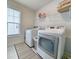 Efficient laundry room with modern washer and dryer units, shelving for storage, and ample natural light at 748 Old Murrells Inlet Rd., Murrells Inlet, SC 29576
