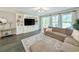 Inviting living room boasts built-in shelving, a comfortable sectional sofa, and lots of natural light at 748 Old Murrells Inlet Rd., Murrells Inlet, SC 29576