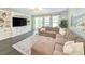Comfortable living room featuring a large sectional sofa, built-in shelving, and bright windows at 748 Old Murrells Inlet Rd., Murrells Inlet, SC 29576