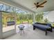 Inviting screened porch with a ceiling fan, comfortable seating, and a view of the lush backyard at 748 Old Murrells Inlet Rd., Murrells Inlet, SC 29576