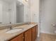 Bathroom featuring double sinks with granite countertops and wood cabinets at 750 Howard Ave. # E, Myrtle Beach, SC 29577