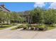 Peaceful courtyard featuring benches surrounded by lush landscaping and brick-paved walkways at 750 Howard Ave. # E, Myrtle Beach, SC 29577