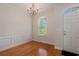 Charming dining room featuring hardwood floors, decorative wainscoting, and an elegant chandelier at 750 Howard Ave. # E, Myrtle Beach, SC 29577