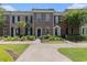 Charming brick townhomes featuring manicured lawns, shuttered windows, and private front entries at 750 Howard Ave. # E, Myrtle Beach, SC 29577