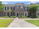 Charming brick townhomes featuring manicured lawns, shuttered windows, and private front entries at 750 Howard Ave. # E, Myrtle Beach, SC 29577