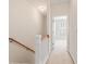 Upstairs hallway with carpeted floors and wooden railing leading to bedrooms at 750 Howard Ave. # E, Myrtle Beach, SC 29577
