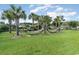 Relaxing hammock area surrounded by palm trees on a well-maintained green lawn at 750 Howard Ave. # E, Myrtle Beach, SC 29577