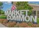 The Market Common sign surrounded by colorful flowers and greenery, creating an inviting entrance at 750 Howard Ave. # E, Myrtle Beach, SC 29577