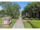 Exterior walkway between units with mature trees and landscaping, enhancing curb appeal at 750 Howard Ave. # E, Myrtle Beach, SC 29577