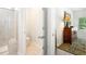 View of the bathroom with glass enclosed shower, toilet, and bedroom dresser with lamp at 775 Harrison Mill St., Myrtle Beach, SC 29579