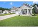 Charming home featuring a well-manicured lawn, inviting porch, and attached garage, perfect for modern living at 775 Harrison Mill St., Myrtle Beach, SC 29579