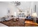 Bright open-concept living room with vaulted ceilings, hardwood style flooring, and bar seating to kitchen at 775 Harrison Mill St., Myrtle Beach, SC 29579