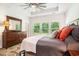 Inviting main bedroom featuring a tray ceiling, a ceiling fan, and backyard view at 775 Harrison Mill St., Myrtle Beach, SC 29579